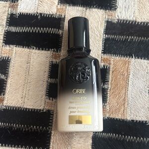 Oribe Balm d’Or Heat Styling Shield in Black and Cream with Gold Accents